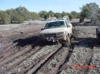 Truck stuck in deep mud on a ranch road